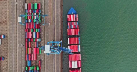 Aerial view of cargo ship loading containers at port Stock Photos