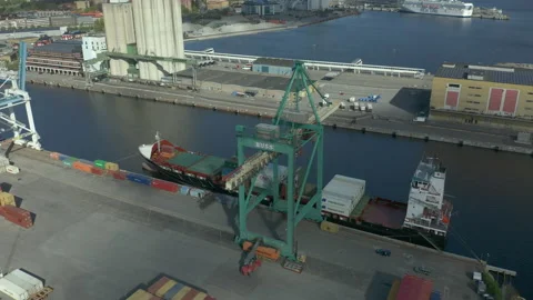 Aerial view of cargo ship moored at container terminal port Stock Footage 130576129