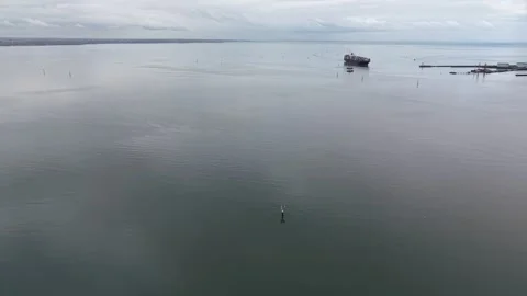 Aerial view of a cargo ship moored in a calm bay Stock-Footage 342326697