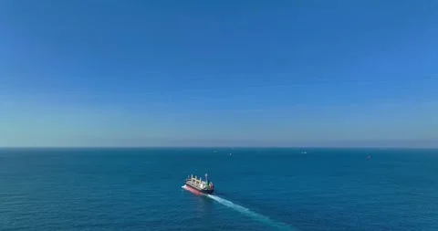 Aerial view of a cargo ship on the move in the middle of the sea Stock Footage 227924479