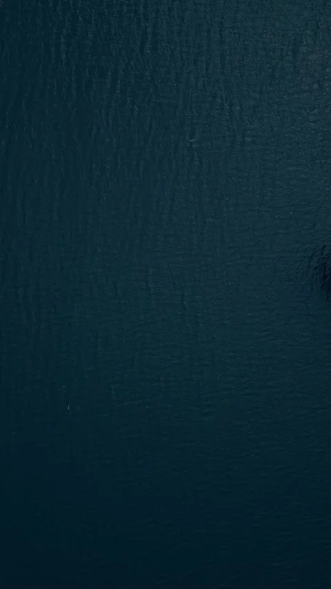 Aerial view of a cargo ship navigating calm waters with colorful shipping Stock Footage 285521076