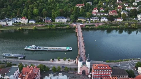 Aerial view of a cargo ship passing beneath the historic Old Bridge , Heidelberg Stock Footage 302229926