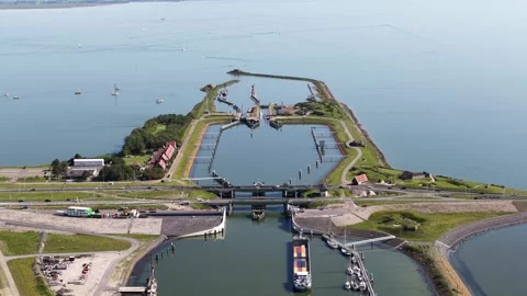 Aerial view of cargo ship passing through lorentz locks at afsluitdijk Video stock 335992513