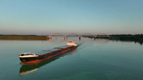 Aerial view. A cargo ship sails on the river at sunset.  스톡 동영상 234449116