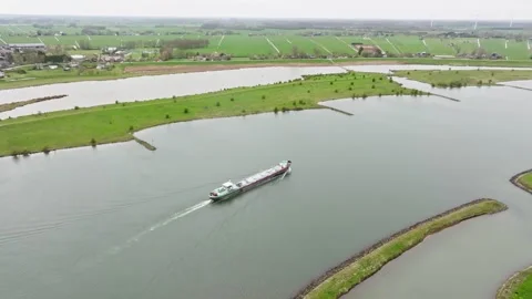 Aerial view of a cargo ship transporting LNG gas sailing in Dutch river Lek Stock Footage 332512242