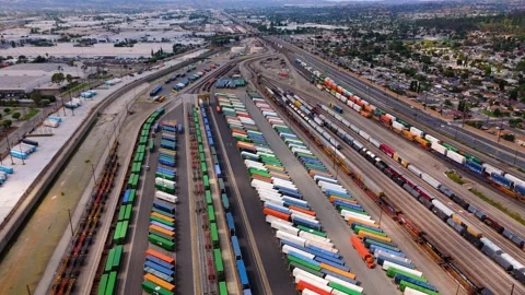 Aerial view of cargo trains and containers at logistics terminal in October 7 Stock Footage 321941048