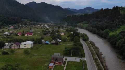Aerial view of the Carpathian mountain valley with green meadows and trees.  Video stock 169104953