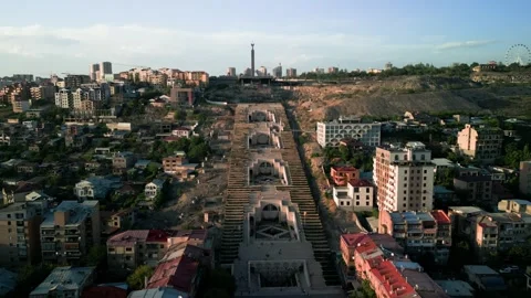 Aerial view of the Cascade Monument, evening sun rays, people walking along the  Stock Footage 250422826