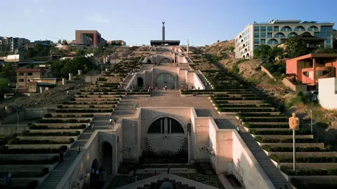 Aerial view of the Cascade Monument, evening sun rays, people walking along the  Stock Footage 250422830