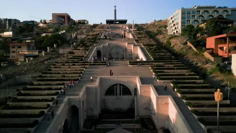Aerial view of the Cascade Monument, evening sun rays, people walking along the  Stock Footage 250422844