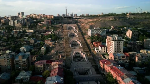 Aerial view of the Cascade Monument, evening sun rays, people walking along the  Stock Footage 250422845