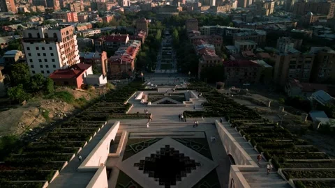 Aerial view of the Cascade Monument, evening sun rays, people walking along the  Stock Footage 250422855