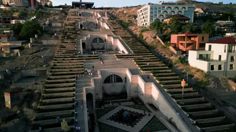 Aerial view of the Cascade Monument, evening sun rays, people walking along the  Stock Footage 250422858