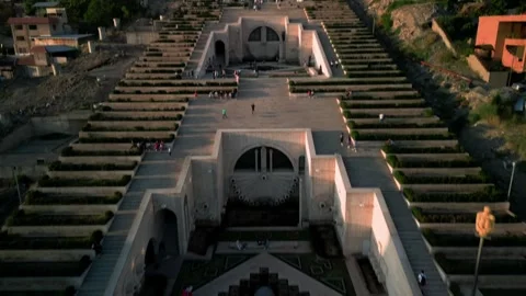 Aerial view of the Cascade Monument, evening sun rays, people walking along the  Stock Footage 250422861