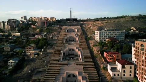 Aerial view of the Cascade Monument, evening sun rays, people walking along the  Stock Footage 250422862