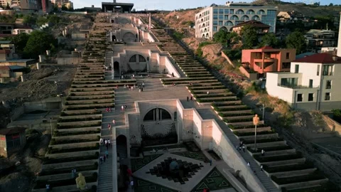 Aerial view of the Cascade Monument, evening sun rays, people walking along the  Stock Footage 250422879