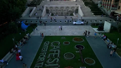 Aerial view of the Cascade Monument, evening sun rays, people walking along the  Stock Footage 250422887