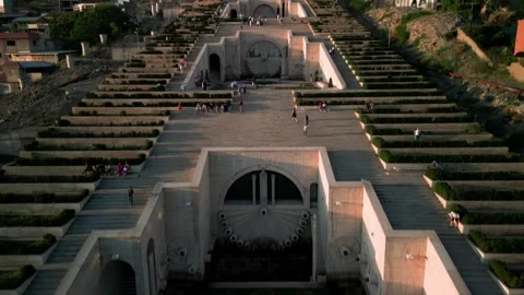 Aerial view of the Cascade Monument, evening sun rays, people walking along the  Stock Footage 250422897