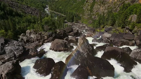 Aerial view of the cascading Uchar waterfall, flowing over rocks and forests Stock Footage 221642945