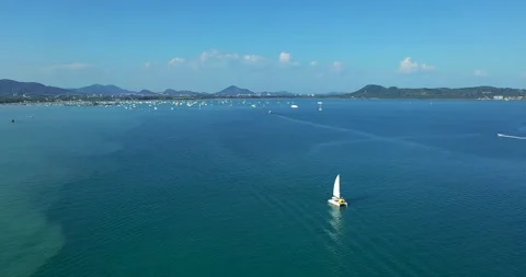 Aerial view. Catamaran goes by sea, camera move closer and fly over vessel, on Stock Footage 151498853