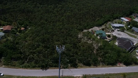 Aerial View of Cell Tower Among Homes in Pioneers Loop, Freeport Bahamas Stock Footage 90105565