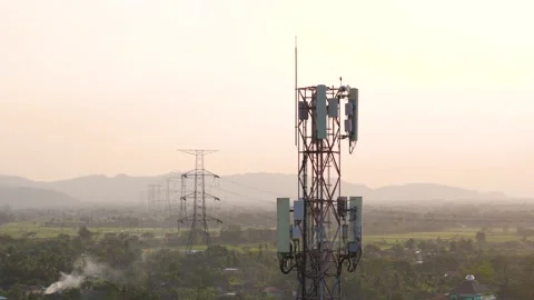 Aerial view of a cell tower and power lines in, Indonesia. Stock Footage 346643469