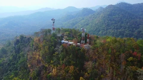 Aerial view of cellular antenna or communications tower on beautiful mountain Stock Footage 301199790