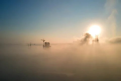 Aerial view of cement factory with high concrete plant structure and tower cr Stock Photos