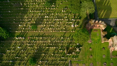 Aerial view of a cemetery with long shadows at sunset Stock Footage 336778673