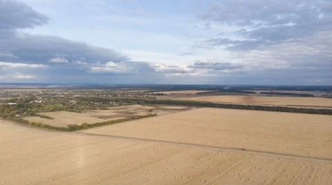 Aerial view of cereal fields after the harvest with haystack and tractor tread Foto stock