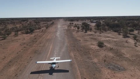 Aerial view of Cessna 172 taxiing on dirt airstrip Stock Footage 92556352