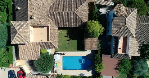 Aerial view of chalets with drone and people running in pool Stock Footage 124219074