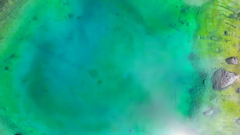 Aerial view of changing reflections on Lago di Carezza in Dolomites Stock Footage 314944045
