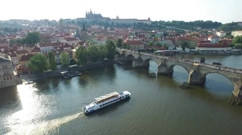 Aerial view of Charles Bridge and boats floating on Vltava River, Prague Stock Footage 55505913
