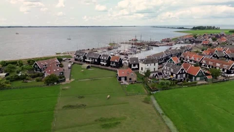 Aerial view of a charming Dutch harbor town with traditional red-roofed houses Stock Footage 314732230