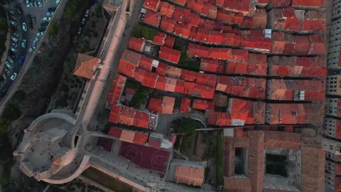 Aerial View of Charming Rooftops and Spiraling Roads Showcasing Unique History Stock Footage 320749028