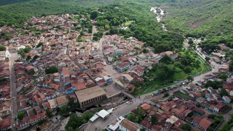 Aerial view of a charming small town nestled in lush green hills Vídeos de archivo 332729061