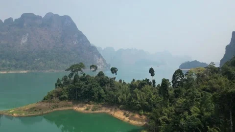 Aerial View of Cheow Lan Lake and Limestone Cliffs in Khao Sok, Thailand Stock Footage 335580593