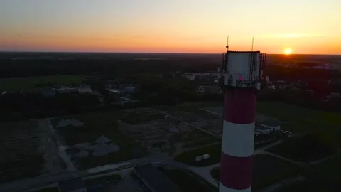 Aerial view of a chimney stack in a small urban area during a orange and Stock Footage 312664529
