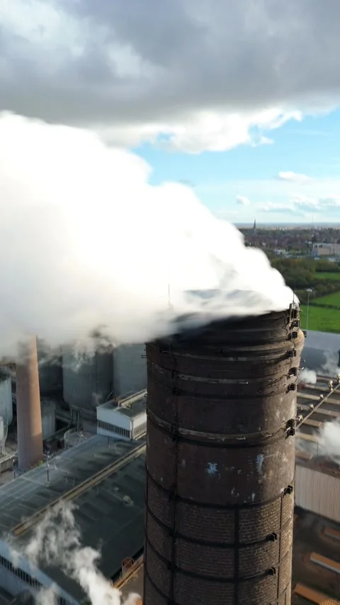 Aerial view of a chimney stack with smoke, United Kingdom. Stock Footage 321131859