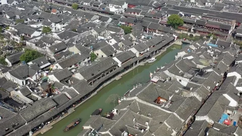 Aerial view of Chinese Jiangnan ancient water town winding river and houses Stock-Footage 336661237