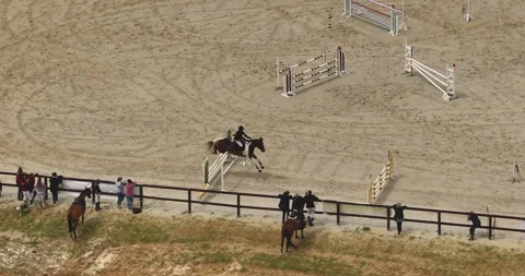 Aerial view. Cinematic slow motion close up of young female horsemanship master 스톡 동영상 250248745
