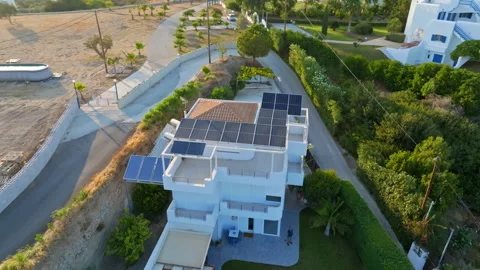 Aerial view circling a solar powered house, sunny evening in Rhodes, Greece Stock Footage 327554069