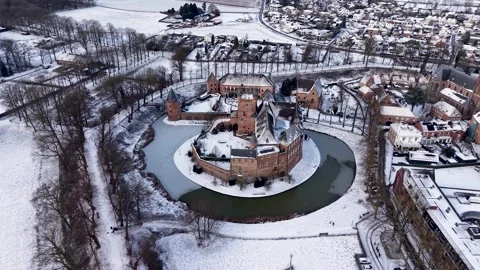 Aerial view of a circular brick castle surrounded by a snowy moat, set Stock Footage 328727462