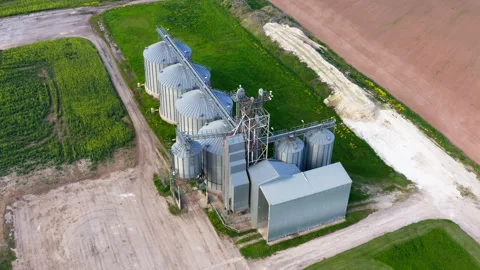 Aerial view, a circular flight of a drone over grain storage and drying tanks. Stock Footage 279671878