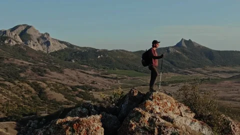Aerial view. A circular panorama around a tourist with a backpack who stands on Stock Footage 150565829