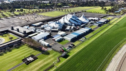 Aerial view of a circus big top tent near a racecourse Stock Footage 340512377