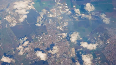 Aerial view of city and fields, High-altitude aerial view of a city surrounded Stock Footage 276229976