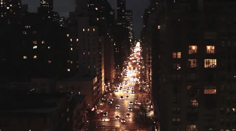 Aerial view of city buildings and street traffic lights at night Stock Footage