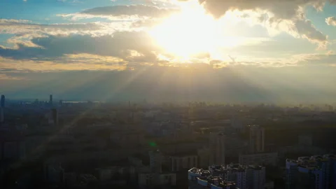 Aerial view of the city in the rays of the bright sun at sunset Stock Footage 145676824